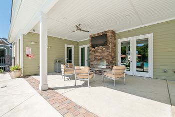 Poolside outdoor lounge with flat screen tvs