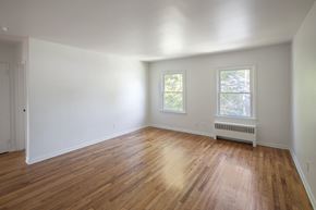 Albany apartment for rent - an empty living room with white walls and wood floors