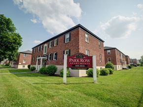 Albany apartment for rent - A brick building with a sign that says "Park Row Apartments" in front of it.