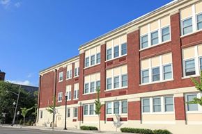 New Brunswick apartment for rent - a large brick building with a blue sky in the background