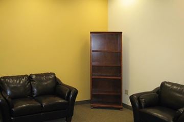 New Brunswick apartment for rent - a living room with leather couches and a bookshelf