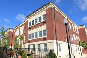 New Brunswick apartment for rent - a large brick building with a fence in front of it