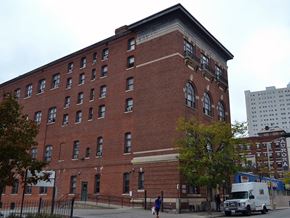 Worcester apartment for rent - a large red brick building with a white truck parked in front