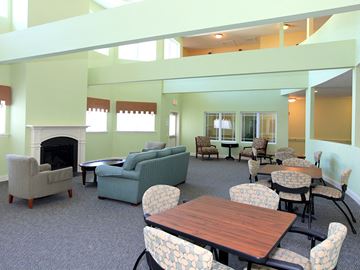 Durham apartment for rent - a living room with couches chairs tables and a fireplace