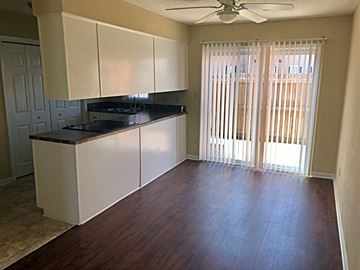 Greenville townhouse for rent - A kitchen with white cabinets and a black countertop.