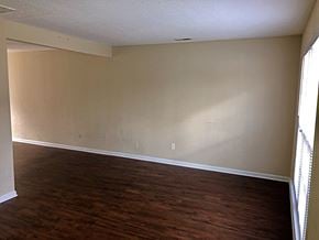 Greenville townhouse for rent - A room with wooden floors and a window on the right side.
