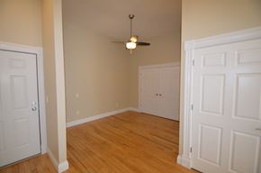 La Crosse apartment for rent - an empty living room with wood floors and a ceiling fan