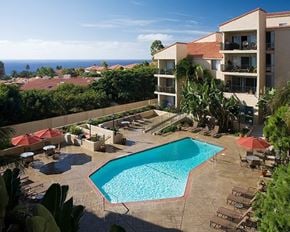 Rancho Palos Verdes apartment for rent - A large swimming pool surrounded by chairs and umbrellas in a resort.