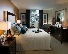 Rancho Palos Verdes apartment for rent - A bedroom with a large bed, a nightstand with a lamp, and a dresser with a mirror.