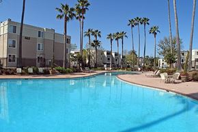Alameda apartment for rent - a large swimming pool with palm trees and apartment buildings