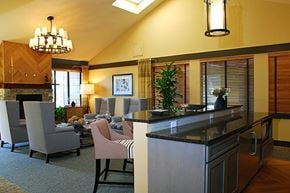 Federal Way apartment for rent - A kitchen with a black counter top and a dining table with chairs.