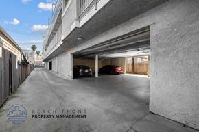 Long Beach apartment for rent - a parking garage in a building with two cars in it