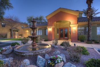 A house with a fountain in front of it