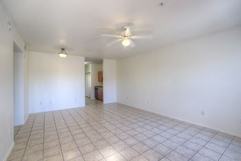 Empty room with a ceiling fan and tiled floor