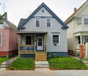 Milwaukee triplex for rent - A blue house with a porch and a white door.