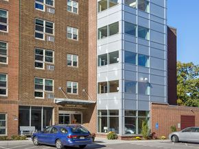 West Roxbury apartment for rent - a blue car parked in front of a brick building