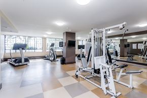 New Westminster apartment for rent - A gym with a variety of equipment including a treadmill, stationary bike, and weight machines.