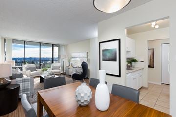 New Westminster apartment for rent - A modern living room with a wooden table and grey chairs.