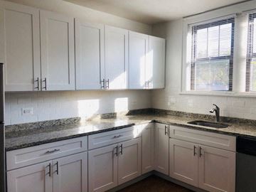 Evanston apartment for rent - a white kitchen with white cabinets and a sink