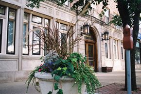 Evanston apartment for rent - a large planter with flowers and plants in front of a building