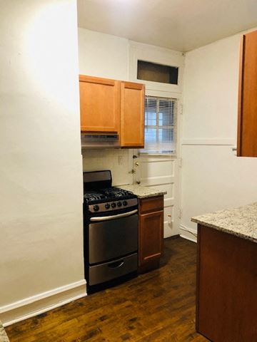 Evanston apartment for rent - a small kitchen with a stove and a window