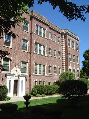 Evanston apartment for rent - a large brick building with a lawn in front of it