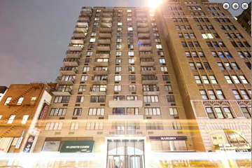 New York apartment for rent - a tall building with a light on the top of it
