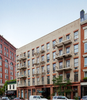 New York apartment for rent - a large brick building with a fire escape on the side