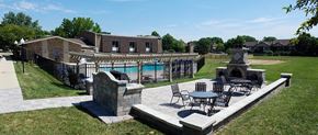 Glen Ellyn apartment for rent - a patio with tables and chairs in front of a swimming pool