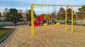 Glen Ellyn apartment for rent - a playground with a red and yellow swing set