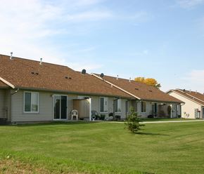 New Richland townhouse for rent - A row of houses with brown roofs and grey walls.