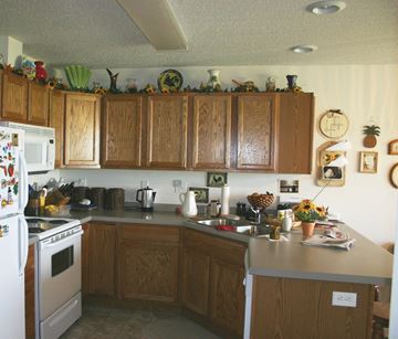New Richland townhouse for rent - A kitchen with wooden cabinets and a white fridge.