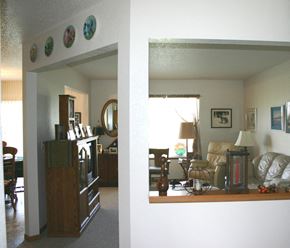 New Richland townhouse for rent - A living room with a couch, chair, lamp, and a picture on the wall.