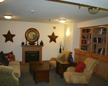 St. Peter apartment for rent - a living room filled with furniture and a fireplace