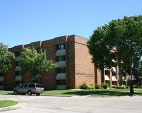 Luverne apartment for rent - a large brick building with a van parked in front of it