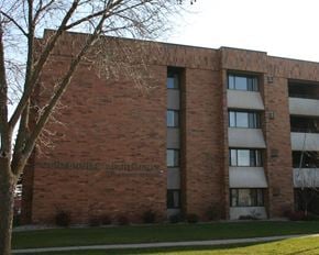 Luverne apartment for rent - a brick building with a tree in front of it