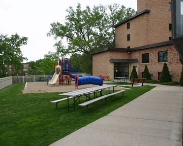 Mankato apartment for rent - a playground and picnic table in front of a brick building