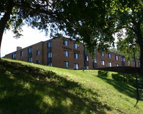 Mankato apartment for rent - a large brick building on a hill with trees