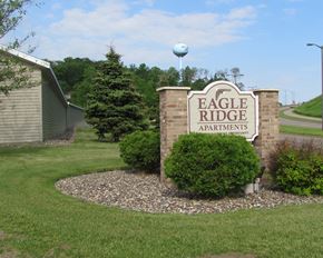 Red Wing apartment for rent - the sign apartments in front of the yard of the building