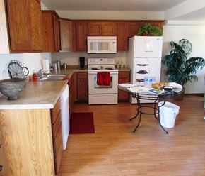 Owatonna townhouse for rent - A kitchen with wooden cabinets and a white fridge.