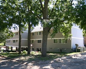 Harmony apartment for rent - the back of the house with trees in the yard