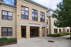 Pittsburgh triplex for rent - a brick building with a sidewalk in front of it