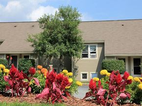 Stow townhouse for rent - a house with a colorful garden in front of it