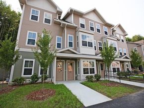 Stow townhouse for rent - an apartment building with a sidewalk in front of it