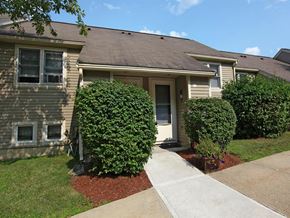 Stow townhouse for rent - a small house with a sidewalk in front of it