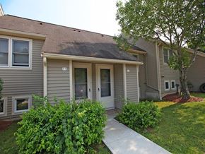 Stow townhouse for rent - a small gray house with a sidewalk in front of it