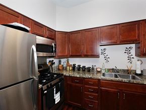 Philadelphia apartment for rent - a kitchen with stainless steel appliances and wooden cabinets