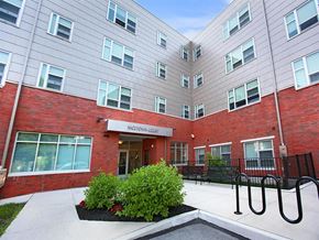 Philadelphia apartment for rent - an entrance to a brick and white building with a courtyard