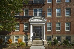 Brighton apartment for rent - the front entrance of a brick building with a black door
