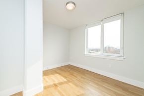 Cambridge apartment for rent - an empty room with a window and wooden floors